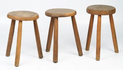 three wooden stools sitting next to each other on a white surface