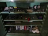 a cabinet with many tools on it in a room
