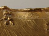 a close up of a gold plate on a table