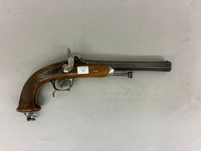 an old gun with a wooden handle on a white surface