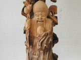 a statue of a man with a beard and a bird on top of it