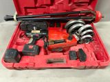 a red tool case with tools in it on a table