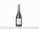 the bottle of wine is sitting on a white table