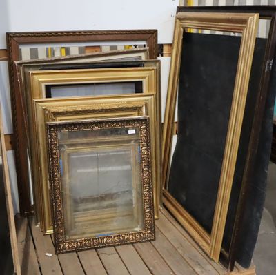 several frames are stacked on top of each other in a room