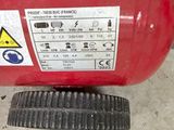 a red fire extinguisor sitting on the ground