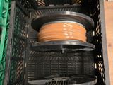 une pile de fils dans une caisse en plastique posée par terre