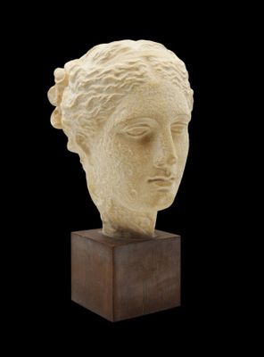 an image of a sculpture of a woman ' s head on a wooden base