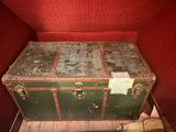 a trunk that is sitting in the corner of a room