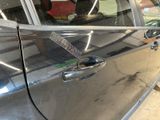 a car door handle that has a sticker on it