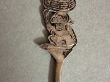 a spoon that has a spoon with a picture of a woman on it