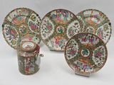 four pieces of chinese famille dishes and a cup and saucer