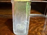 a glass of water sitting on a table with a number on it