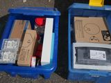 two boxes with different items in them sitting on the ground