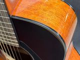 a close up of an acoustic guitar on a table