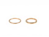 a pair of gold rings on a white background