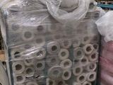 many rolls of toilet paper on a pallet in a warehouse