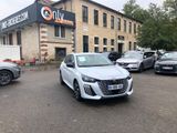 many cars parked in front of a building in a parking lot