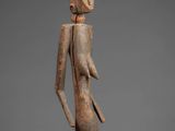 a statue of a woman sitting on top of a wooden block