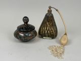 a small glass jar and a wooden spoon next to each other
