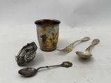 a cup, spoon, and spoon rest on a table