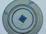 a blue and white plate with a design on it