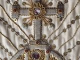 an image of a close up of a cross on a white cloth