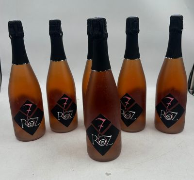 six bottles of wine are lined up in a row on a table