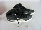 pair of black and white sneakers sitting on top of a white surface
