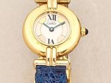 a gold watch with a blue strap around it
