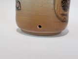 a close up of a ceramic cup with a design on it