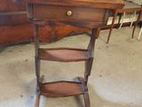 a small wooden table with a shelf on top of it