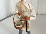 a figurine of a man with a basket on a table