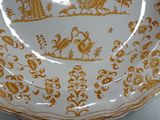 a plate that has a gold and white design on it