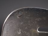 a close up of a metal object with a small bug on it