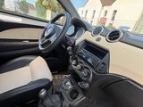 the interior of a small car with a steering wheel and dashboard