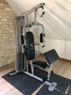 a gym equipment set up in the corner of a room