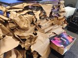 a pile of books and a pair of shoes on top of a pile of cardboard