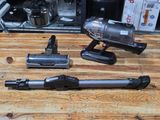 two vacuums that are sitting on a wooden table