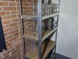 a brick wall in a kitchen with shelves and a window