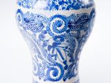 a blue and white vase sitting on a white surface