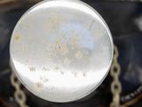 a close up of a metal object with a chain around it