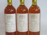 three bottles of wine sitting next to each other on a white surface