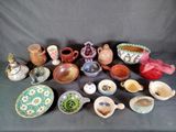 many different types of pottery sitting on a table