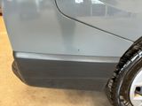 a close up of a tire on a car in a garage