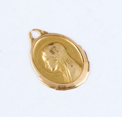 an image of a gold medal with a woman ' s face on it