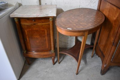 a small table with a marble top next to a cabinet