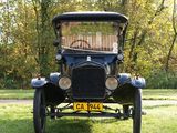 a old car that is parked in the grass