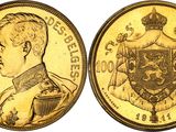 a gold coin with a portrait of a man and a coat of arms