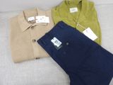 three pairs of men ' s clothing sitting on a couch next to each other