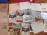 many old postcards on a table with a blue suitcase